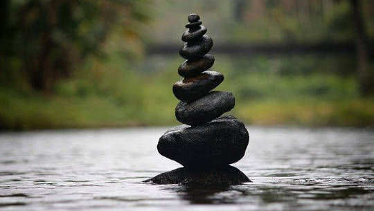 On Perfectionism: Allowing Ourselves to Relax stack of pebbles perfectly balanced