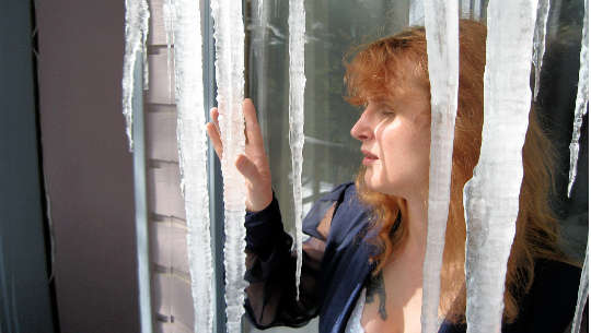 Everybody Hurts Sometimes woman looking out a door through a "curtain" or icicles