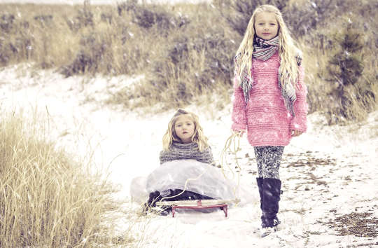 Our Childhood Relationships Affect How We Build Our Families two siblings in the snow