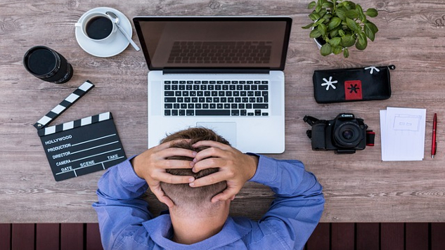How to Manage Our Inner Saboteur man sitting in front of his laptop with his hands behind his head