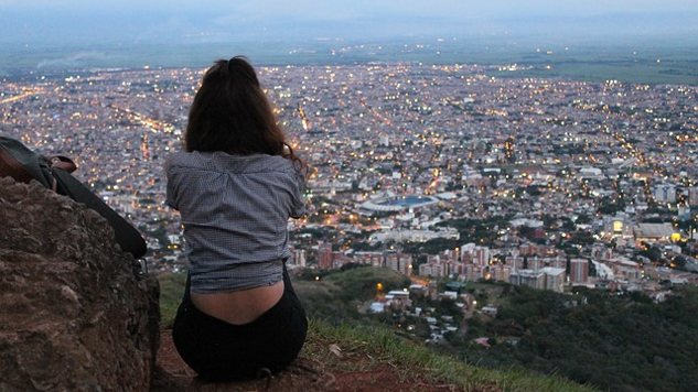 Opening Our Hearts to the Practice and Gift of Compassion a woman sitting overlooking a city