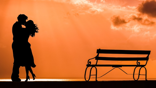 Taking Responsibility for Our Emotional Clumsiness a couple kissing standing next to a bench on a beach at sunset