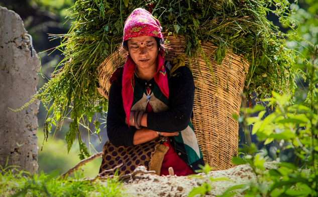 Self-Love Practices: Connecting with Your True Self a young woman sitting on the ground in a rural setting