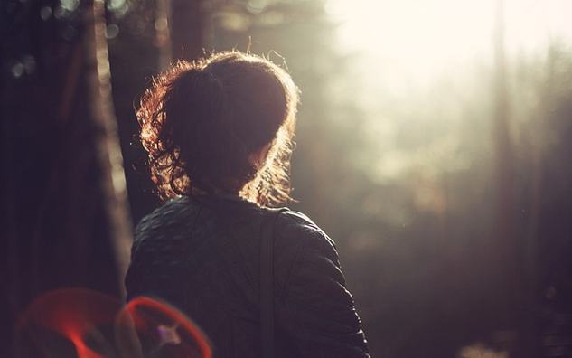 Healing Ancestral Wrongdoings and Dysfunctional Patterns woman staring out into the light