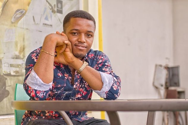 How to Strengthen Your Belief in Unlimited Health and Healing photo of a confident black man sitting at a table