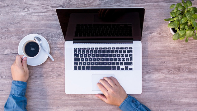 Is it a Like, Preference, a Habit, or an Addiction? a man at his laptop with a cup of coffee