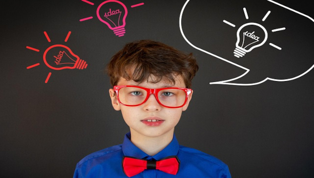 Is Excellence Really Its Own Reward? A schoolboy wearing red framed glasses and a red bow-tie. Image by Victoria from Pixabay