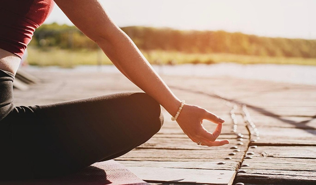 The Power of a 3-Minute Meditation to Transform Your Life a person meditation with hands in a mudra pose