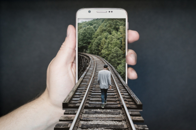 InnerSelf Magazine: May 19, 2025. Image of a person walking on the train tracks and somehow entering into a phone in someone's hand. Image by David from Pixabay.